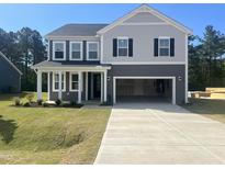 Charming two-story home showcasing a neutral color scheme, a two-car garage, and a well-manicured lawn at 98 Tee Time Ter, Benson, NC 27504