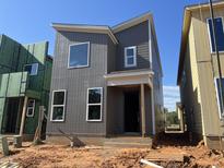 Modern gray two-story home with white window trim and a minimalist design in a construction zone at 101 Parkland Dr, Pittsboro, NC 27312