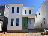 New construction, white two-story home with large windows, showcasing modern design at 107 Parkland Dr, Pittsboro, NC 27312
