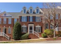 Beautiful brick townhouse featuring black shutters and landscaped front entrance at 107 Westside Dr, Chapel Hill, NC 27516