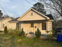 Charming one story home featuring a cozy front porch and freshly landscaped yard at 1103 Gaston St, Smithfield, NC 27577