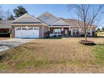 Charming single-story brick home with a well-maintained front yard and two-car garage at 1176 Andrews Ct, Creedmoor, NC 27522