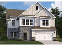 Charming two-story home featuring stone accents, a two-car garage, and lush landscaping at 118 S Stonemill Trl # Homesite 231, Clayton, NC 27520