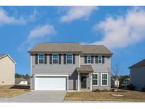 Charming two-story home with gray siding, black shutters, and a well-maintained front yard at 140 Ashberry Ln, Franklinton, NC 27525