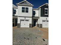 A newly built townhome features a one-car garage and clean white siding under a clear blue sky at 18 Twin Birch Dr, Angier, NC 27501