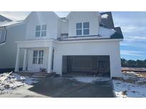New construction of two story home with white siding, 2-car garage and snow covered yard at 1805 Bright Lantern Way, Wendell, NC 27591