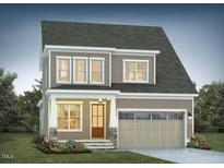 Charming two-story home featuring a covered porch, attached two car garage, and manicured landscaping at 1805 Bright Lantern Way, Wendell, NC 27591