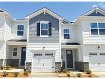 Charming townhome with white siding, a garage, gray shingles, and a well-maintained lawn at 22 Twin Birch Dr, Angier, NC 27501