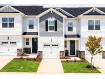 New townhomes with light siding, well maintained lawn and landscaping at 22 Twin Birch Dr, Angier, NC 27501