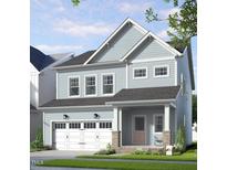 Charming two-story home with attached garage, landscaped yard, and inviting front porch at 269 Beacon Dr, Pittsboro, NC 27312