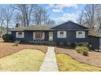 Charming one-story home with dark siding, white shutters, and a well-maintained front yard at 412 Lynchester Ct, Raleigh, NC 27615