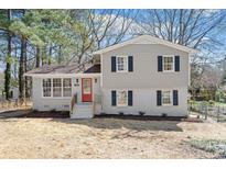 Charming renovated home with a red door, fresh paint, updated windows and new porch steps at 4204 Green Rd, Raleigh, NC 27604