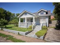 Charming gray two-story home featuring a welcoming front porch and landscaped front yard at 508 S Swain St, Raleigh, NC 27601