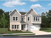 Two-story home with gray siding, brick accents, attached two-car garage and well-manicured lawn at 556 Contempo Dr # 22, Rolesville, NC 27571