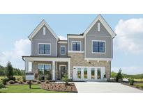 Charming two-story home with gray siding, brick accents, and a welcoming front porch at 556 Contempo Dr # 22, Rolesville, NC 27571