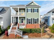Charming two-story home with a brick foundation and welcoming double porches at 6609 Truxton Ln, Raleigh, NC 27616