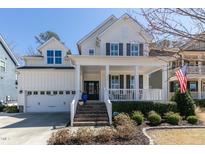 Charming two-story home featuring a welcoming front porch, well-manicured landscaping, and a classic architectural style at 1025 Chelsea Run Ln, Apex, NC 27502