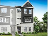 New construction townhome featuring a stylish exterior with vertical siding and a charming covered entry at 1027 Zelkova Ln, Chapel Hill, NC 27517