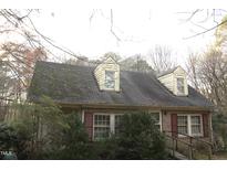 Charming brick home featuring upper dormer windows and traditional shutters at 105 Mary St, Carrboro, NC 27510