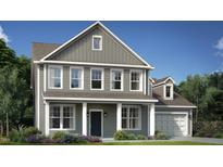 Charming two-story home featuring gray siding, white trim, a welcoming porch, and a neatly landscaped front yard at 1101 Owen Park Drive, Gibsonville, NC 27249
