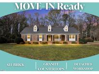 Charming, all-brick, one-story home featuring a well-manicured lawn and a welcoming front porch at 1192 Princeton Kenly Rd, Kenly, NC 27542