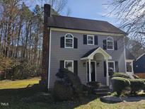 Charming two-story home with gray siding, black shutters, and manicured landscaping at 3615 Open Sight Ct, Raleigh, NC 27616
