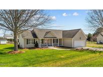 Charming single-story home features a well-manicured lawn, inviting porch, and attached two-car garage at 42 Galaxy Dr, Garner, NC 27529