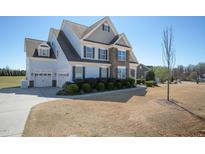 Stunning two-story home with stone accents, manicured shrubs, and a spacious two car garage at 71 Del Corso Ct, Clayton, NC 27527