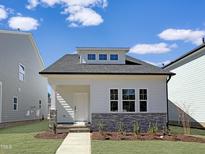 Charming single Gathering home with stone accents, manicured lawn, and a welcoming front entrance at 761 Portland Rose Dr, Knightdale, NC 27545