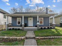 Charming single-story home with a welcoming front porch and well-manicured lawn at 908 Spruce St, Durham, NC 27701