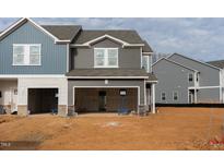 New construction exterior view showcases a two-story home with an unfinished garage and yard at 1173 Abbott St, Mebane, NC 27302