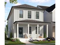Charming two-story home with light siding, a welcoming front porch, and beautifully landscaped front yard at 123 Weavers Grove Dr, Chapel Hill, NC 27514