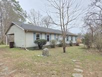 Ranch-style home with light siding, blue shutters, and a covered carport, offering classic charm at 1545 N Nc 87, Elon, NC 27244