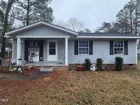 Charming single-story home featuring a covered porch, well-maintained yard, and classic curb appeal at 2325 Quartz Ct, Raleigh, NC 27610