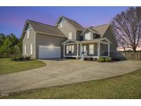 Charming two-story home featuring a spacious front yard, attached garage, and welcoming covered porch at 288 Joseph Alexander Dr, Fuquay Varina, NC 27526