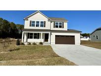 Charming two-story home with a neutral color palette, a two-car garage, and a well-maintained front yard at 328 Earnest Way # L33, Kenly, NC 27542