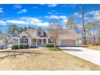Charming single-Gathering home with a manicured lawn, attached garage, and welcoming front porch at 34 Triton Ct, Clayton, NC 27520