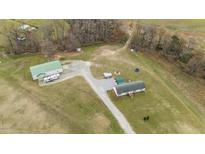 Expansive property with home, large outbuilding, recreational area, and long driveway at 4194 Abattoir Rd, Angier, NC 27501