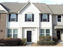 Charming townhouse with neutral siding, black door and shutters, and well-maintained landscaping at 4519 Tarkiln Pl, Wake Forest, NC 27587