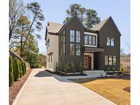 Stunning two-story home with a modern design, dark exterior and double door entry at 604 Edmund St, Raleigh, NC 27604