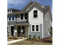 Charming two-story home with white siding, large windows, and a well-manicured lawn at 6411 Granite Quarry Dr, Raleigh, NC 27610