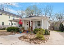 Charming home featuring a landscaped front yard, welcoming front porch and a driveway, offering classic appeal at 711 S East Street St, Raleigh, NC 27601