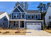 Charming two-story home featuring a 2-car garage, landscaped yard, and a welcoming covered front porch at 724 Red Arrow Drive Dr, Knightdale, NC 27545