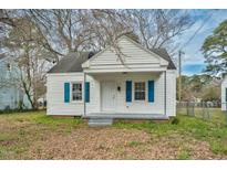 Charming white home with blue shutters and a cozy front porch is ready for move in at 824 S Tillery St, Rocky Mount, NC 27803