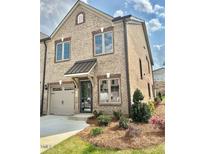 Charming brick home with manicured landscaping, an attached garage, and a welcoming front entrance at 1041 Beechcraft Dr # 119, Mebane, NC 27302