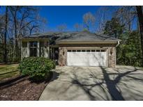 Charming home featuring a brick facade, a two-car garage and a well-manicured lawn at 114 Twin Springs Ln, Angier, NC 27501