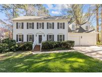 Charming two-story home with a well-manicured lawn and attached two car garage at 1605 Bridgeport Dr, Raleigh, NC 27615