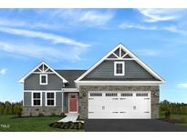 Charming two-story home featuring stone accents and a spacious two-car garage, set against a bright blue sky at 27 Artesa Ct, Fuquay Varina, NC 27526