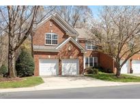 Charming red brick two-story home with a two-car garage and mature landscaping at 5036 Isabella Cannon Dr, Raleigh, NC 27612