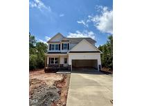 Two-story home with white siding, black shutters, covered porch, and an attached two car garage at 60 Moonraker Dr, Spring Hope, NC 27882